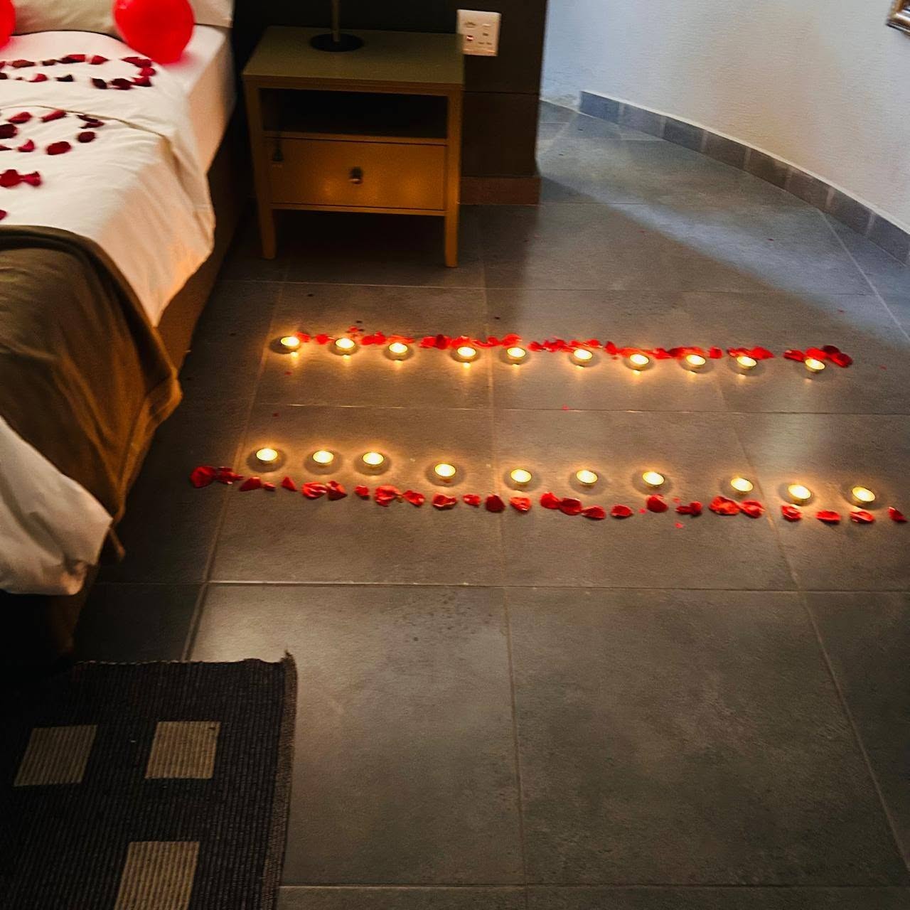 Guest room prepared with candles and rose petals for a special occasion